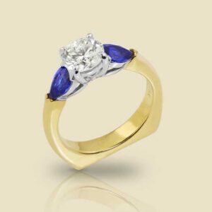 18K Yellow Gold and Platinum Ring with 90ct F Color Diamond and 60ctw Pear Shape Sapphires